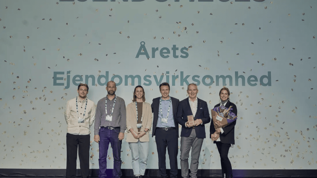 Balder employees on stage receive the 2025 Real Estate Company of the Year award.