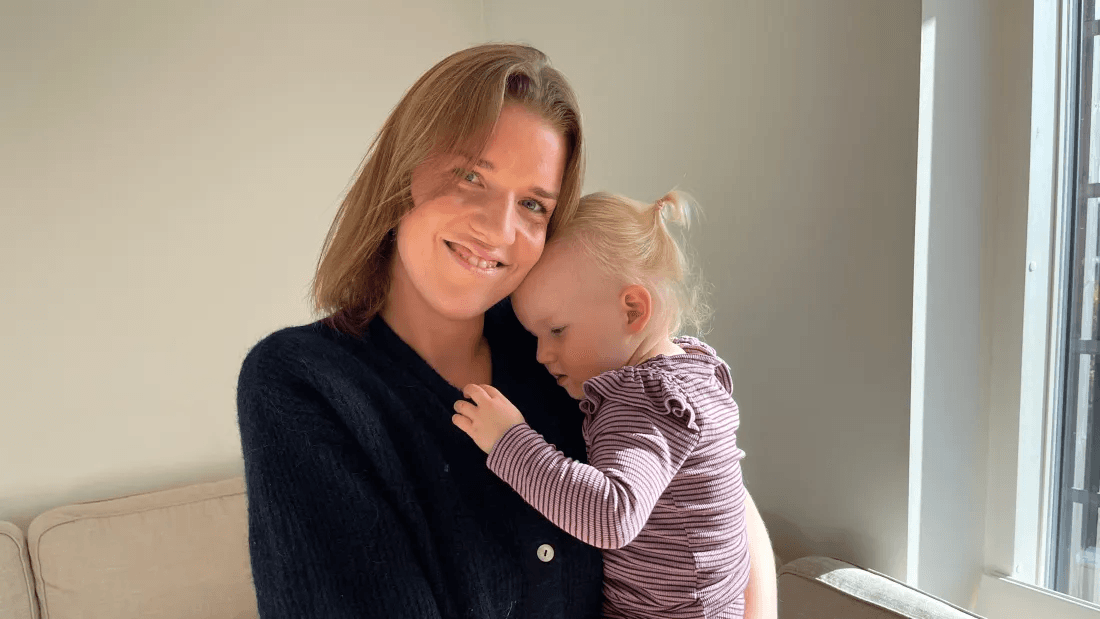 Mille with her daughter on her arm