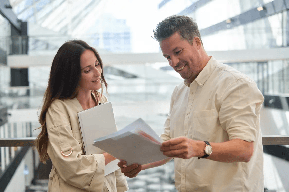 Mark and Michella, employees at Balder, look at documents together
