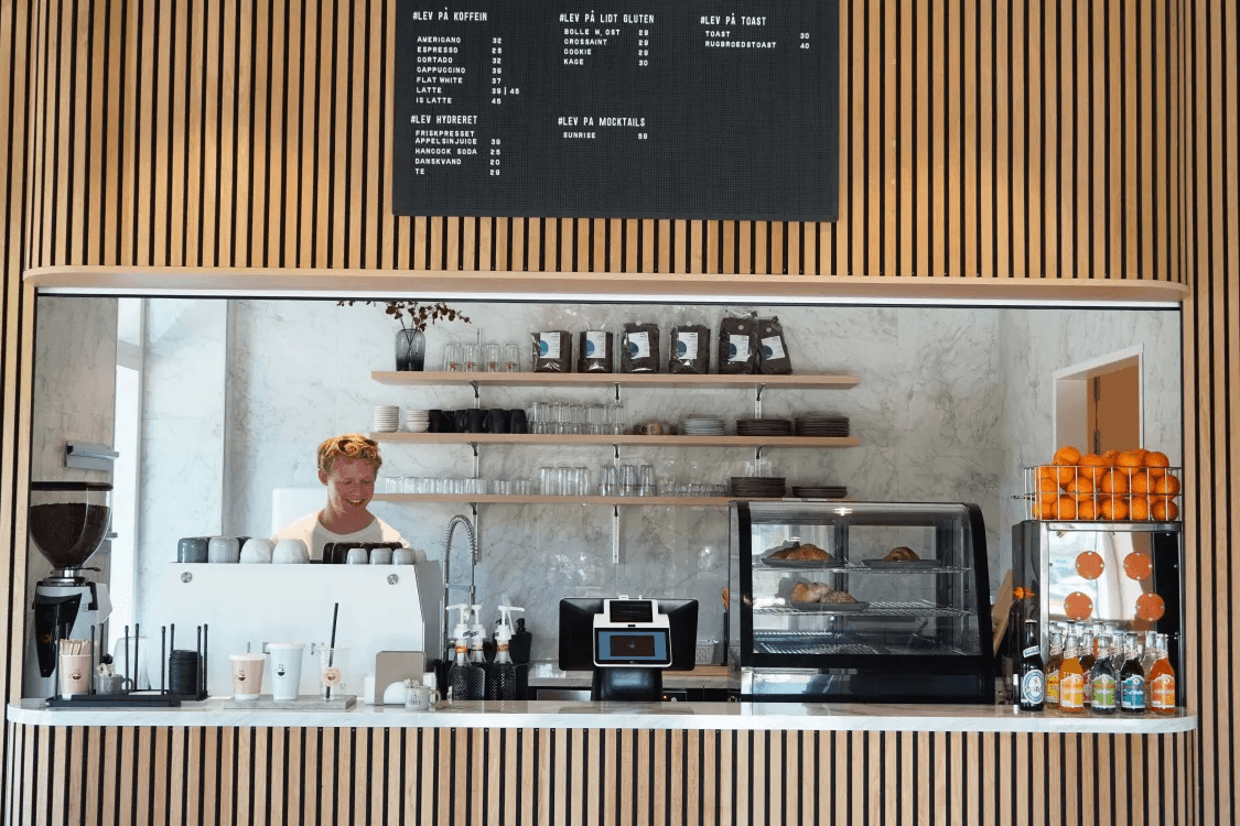 An employee stands in the Live a Little coffee bar in Høje Taastrup.